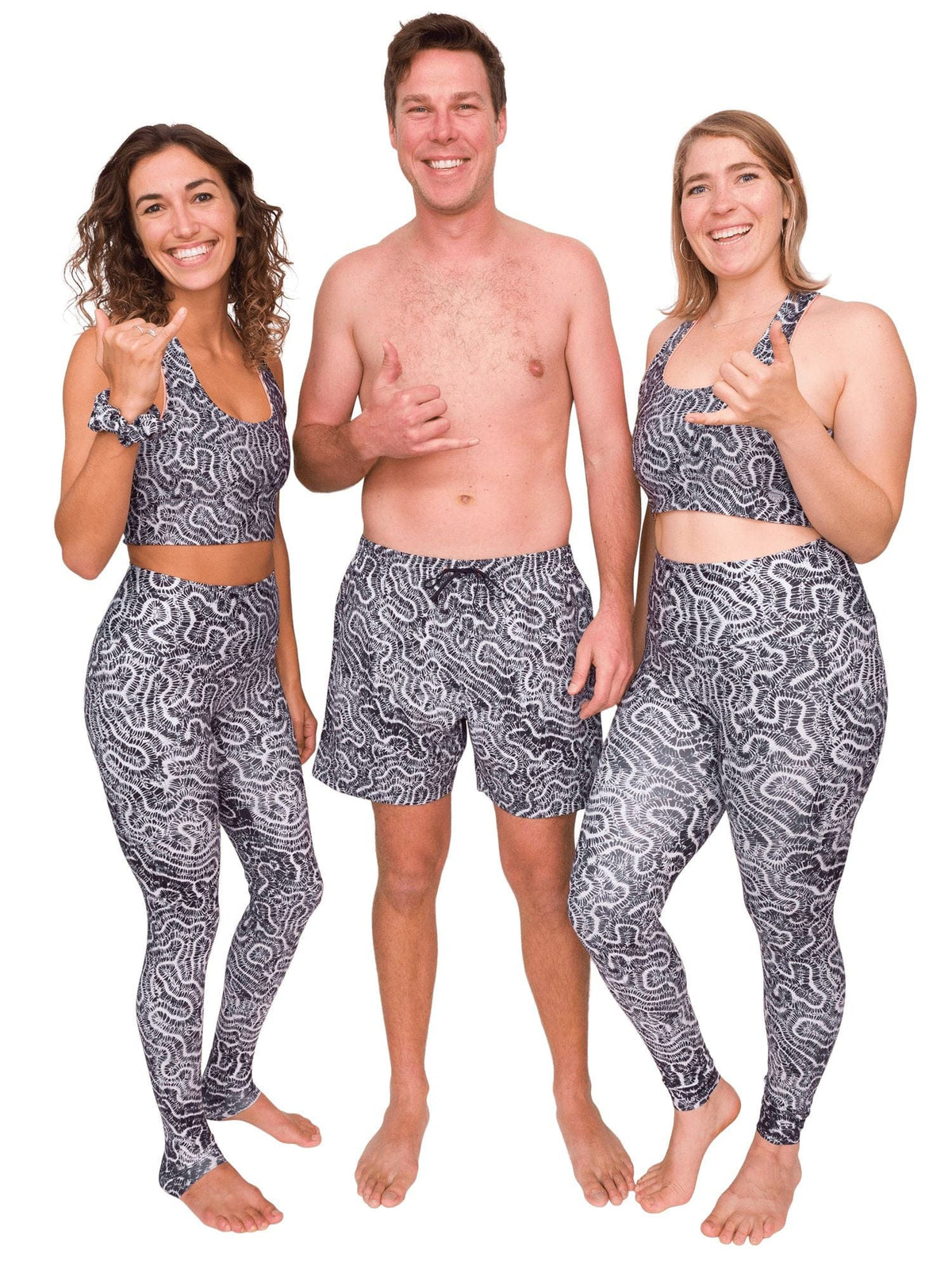matching brain coral leggings, shorts, and top on a man and a two women