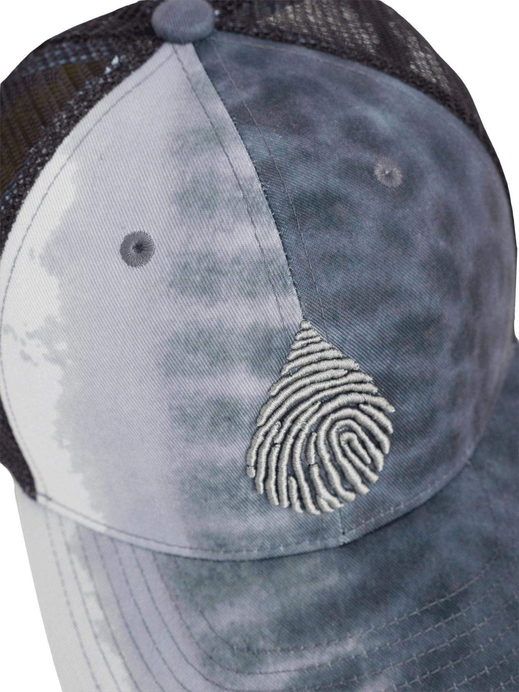 Close up, top down view of the waterlust logo embroidered on a tiger shark printed recycled trucker cap hat